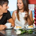 Young couple drinking coffee on romantic anniversary date.