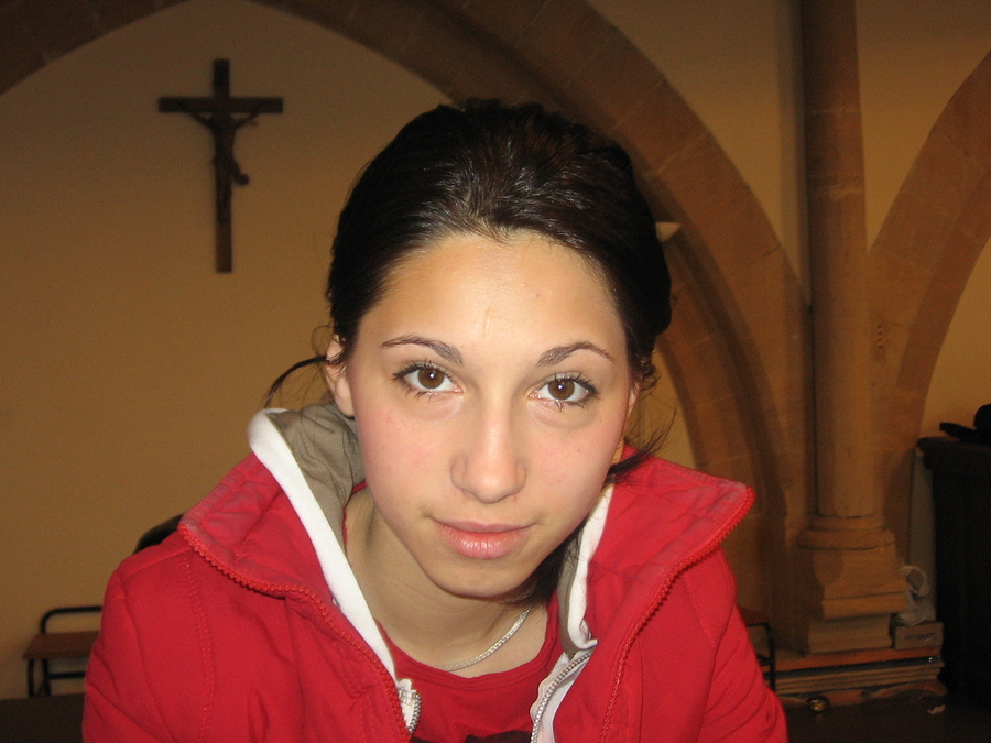 Brunette girl in a church crucifix and column in the background ** Note: Slight blurriness, best at smaller sizes